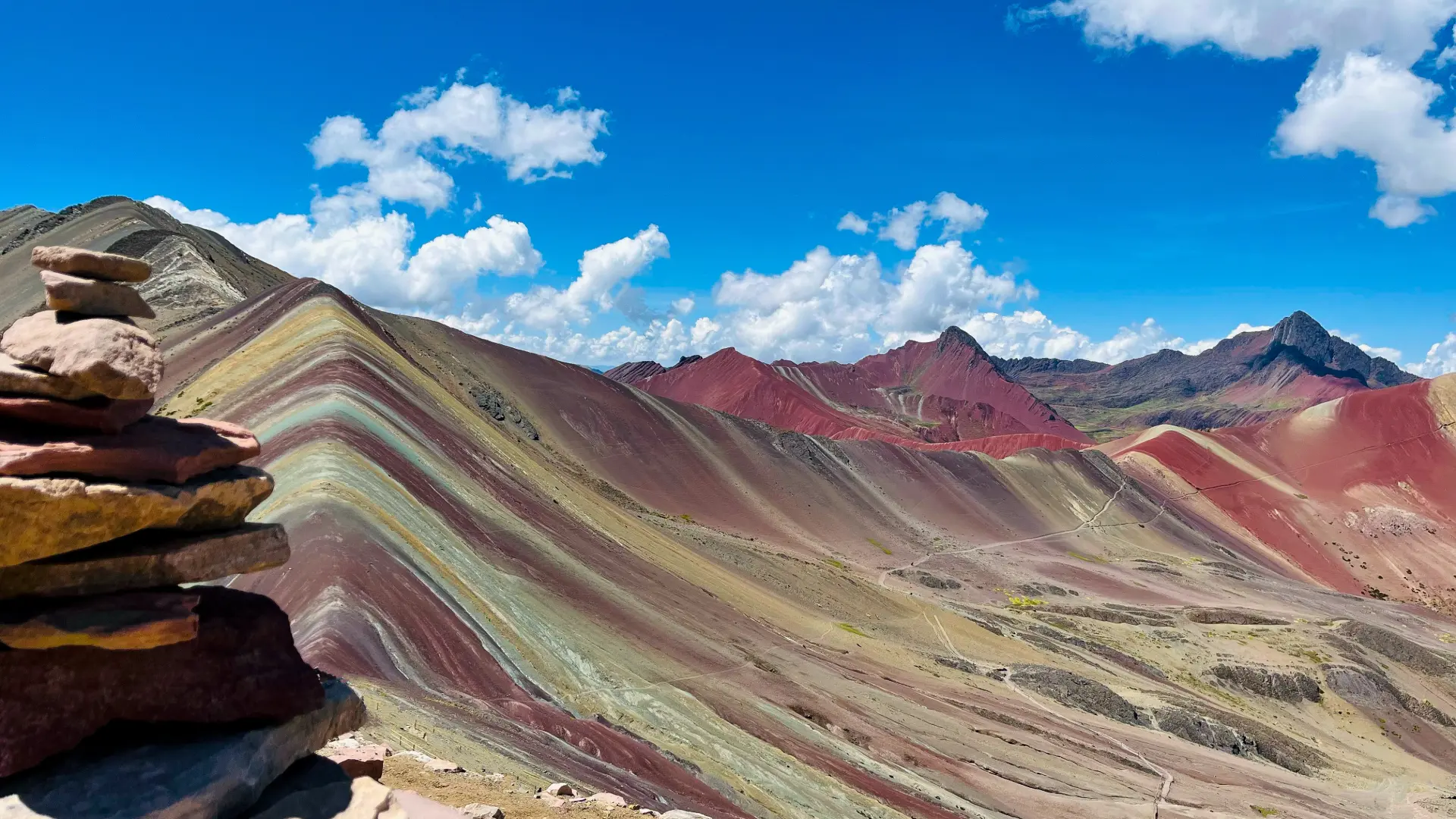 Tourists trekking slowly up the Rainbow Mountain path