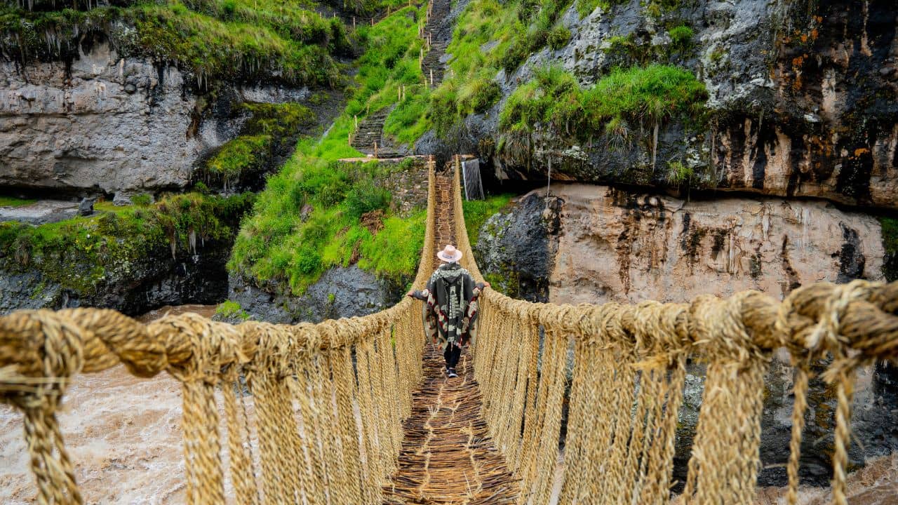 Tourists crossing the Qeswachaka rope bridge during the dry season